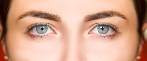 woman with blue eyes filling the screen looking into camera to represent eye surgery blepharoplasty at europe surgery