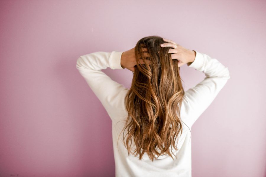 young brunette woman touching hair