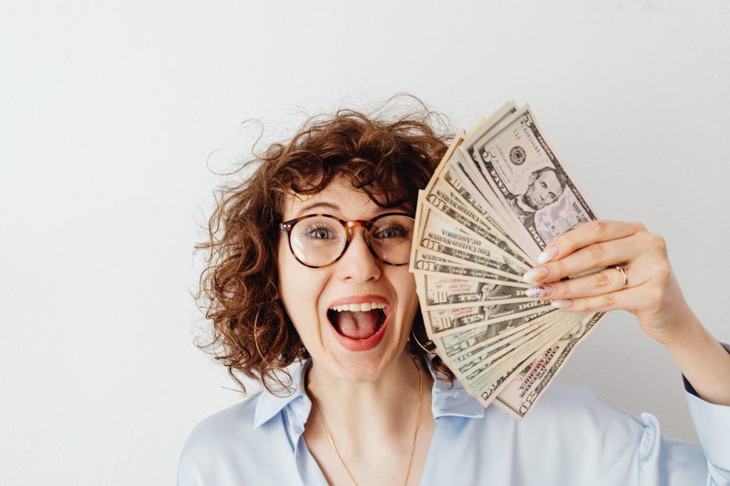 how much plastic surgery in turkey costs - woman holding money